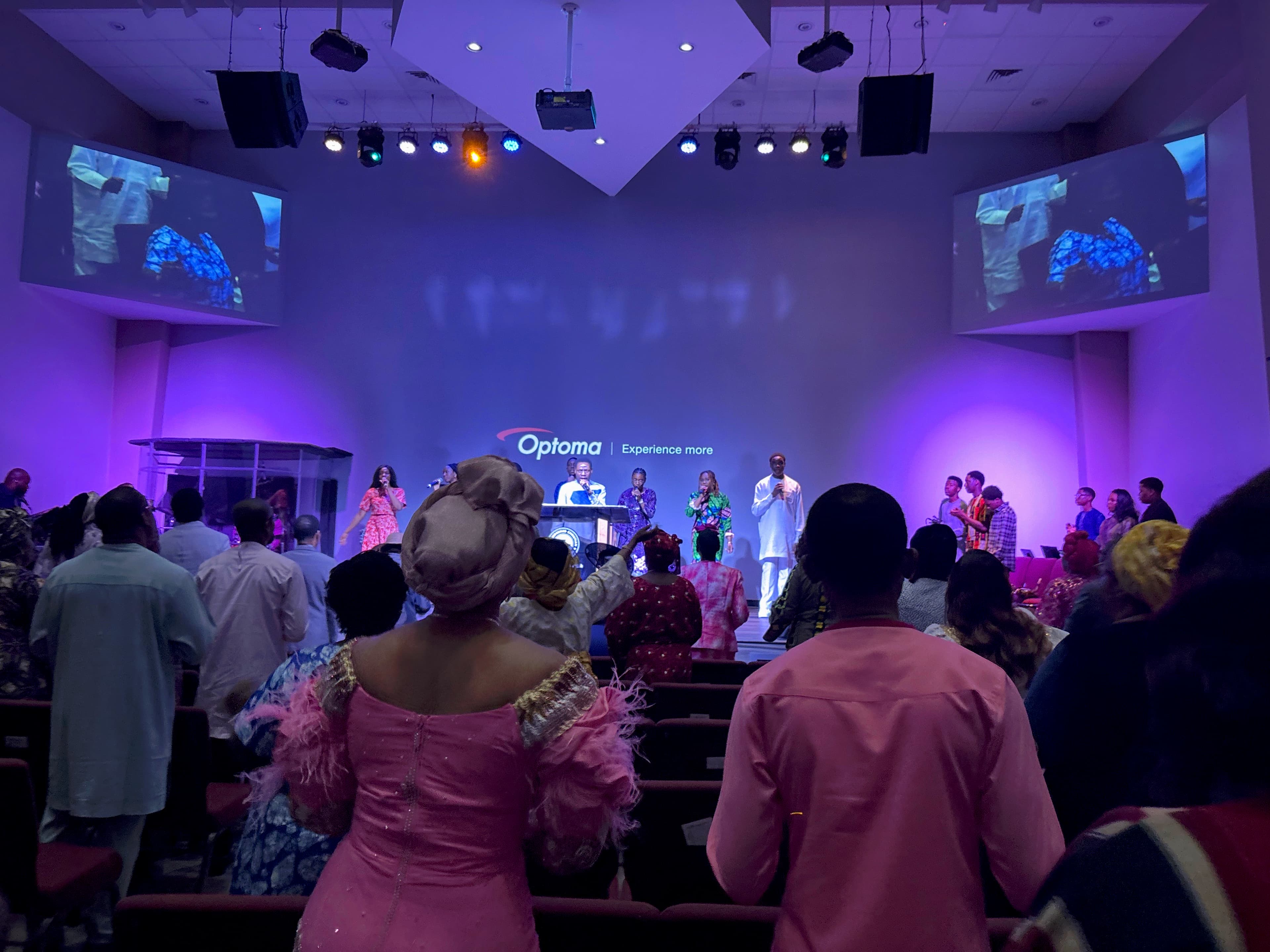 Shiloh Mega Parish congregation standing in worship as pastors minister on stage during Thanksgiving Service