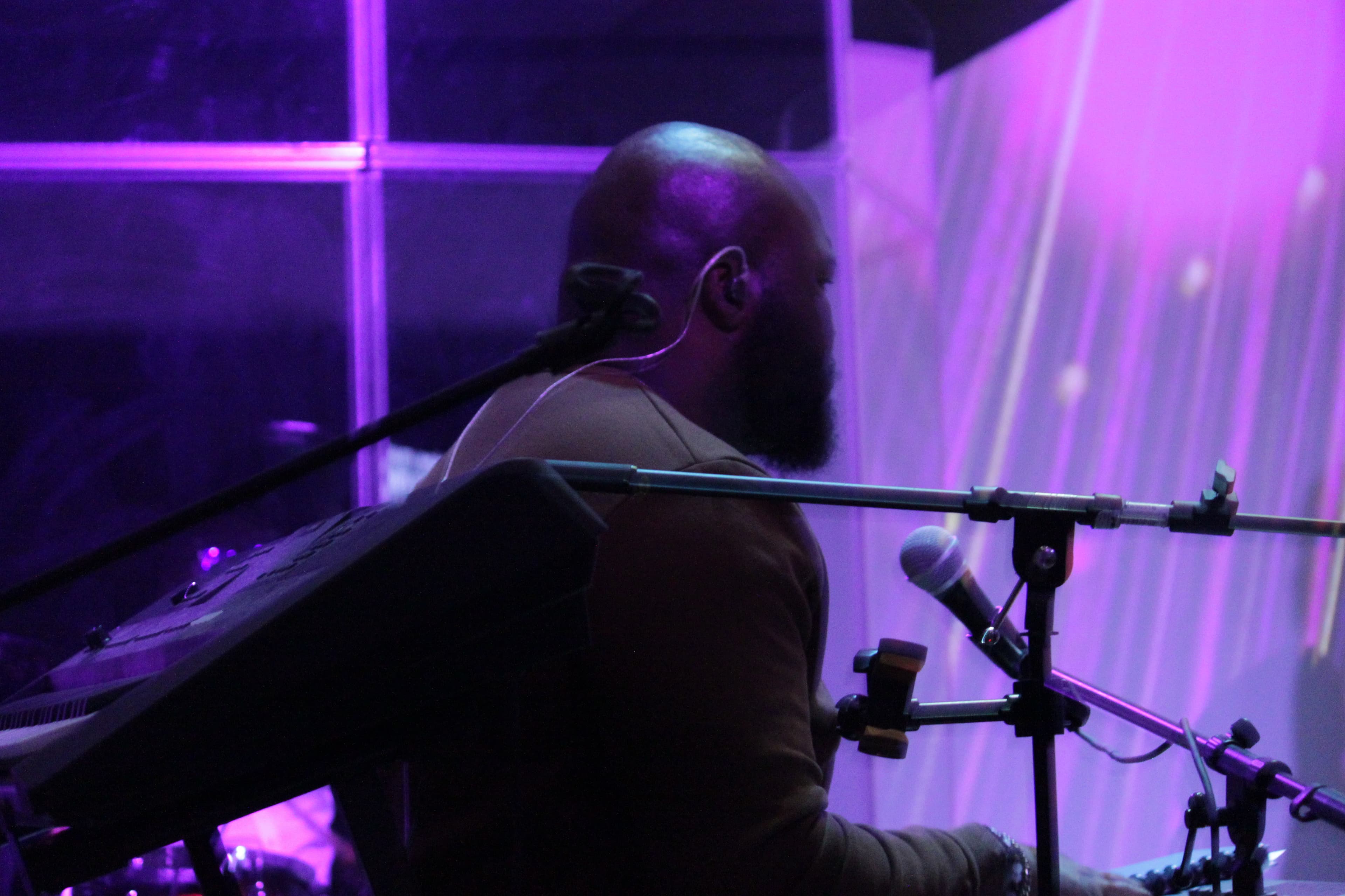 Musician at keyboard with audio equipment