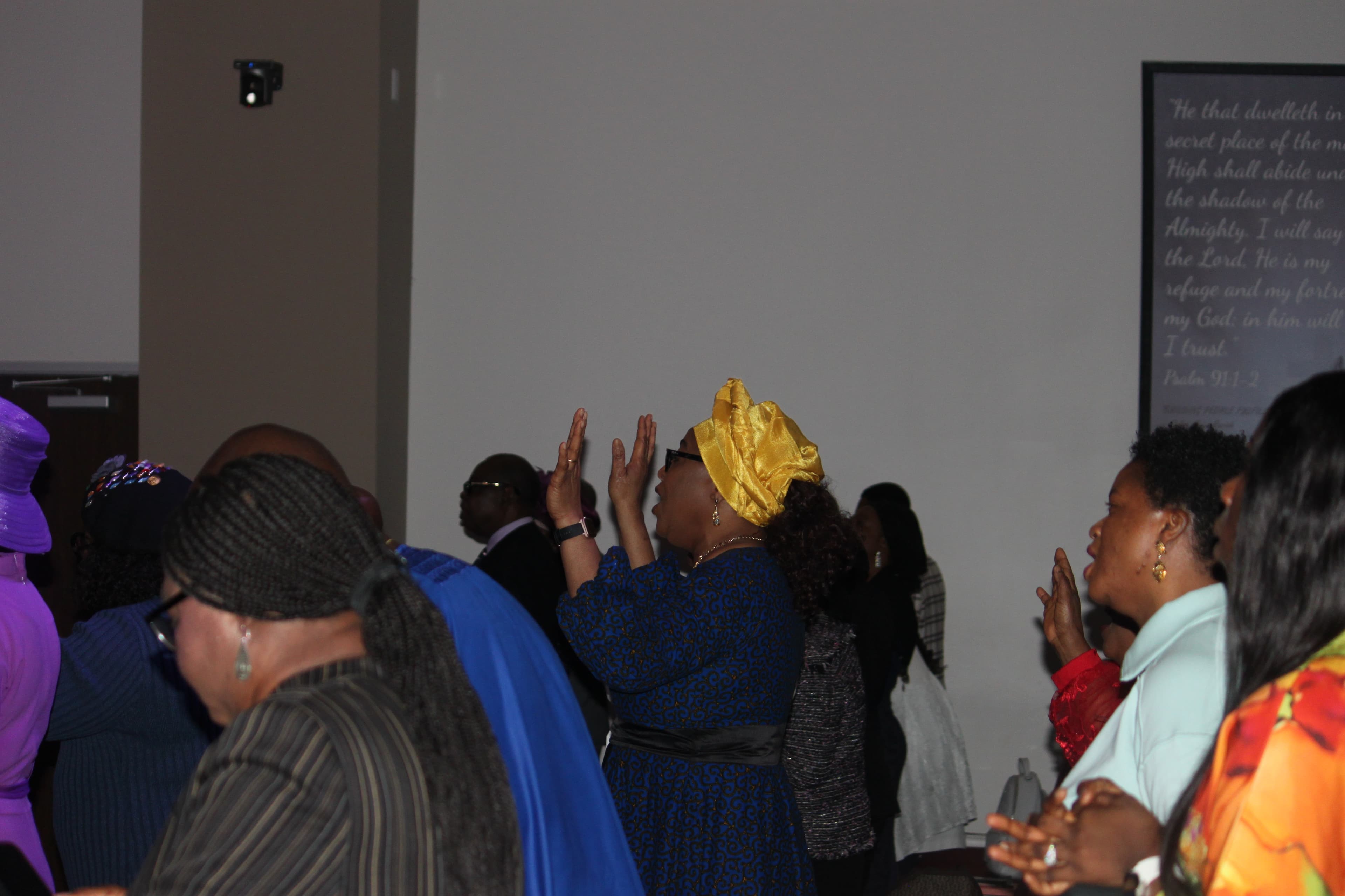 Women of Shiloh Mega Parish in worship with hands raised